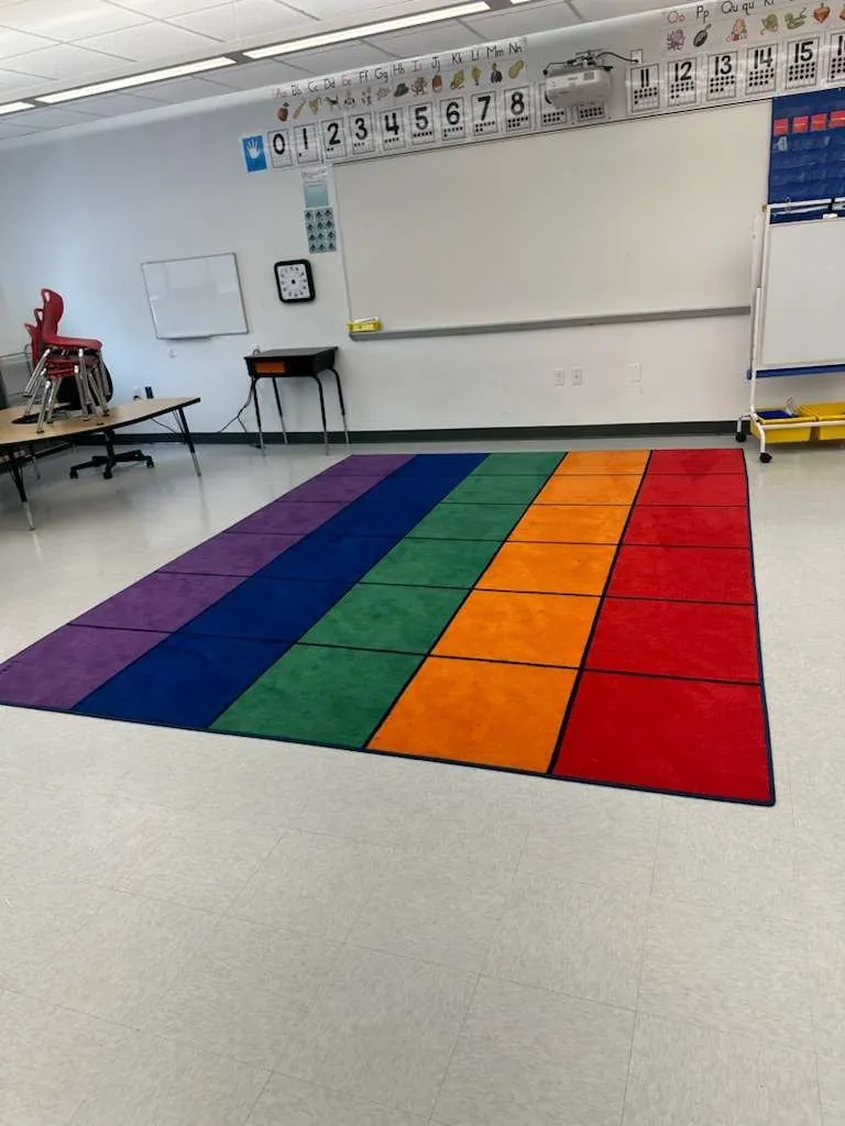 Classroom floor with a rainbow rug and polished tile