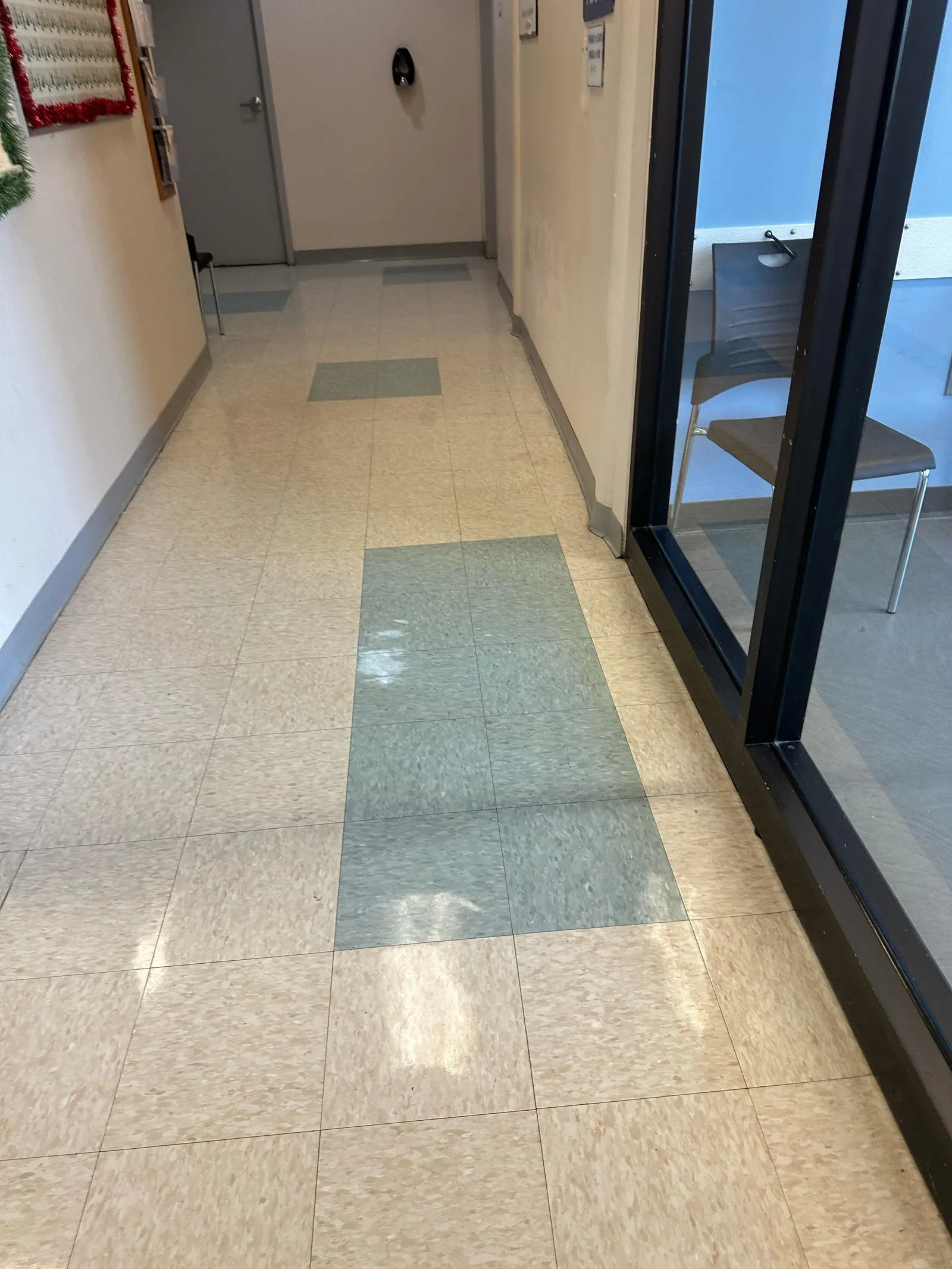 Waxed tile corridor with glass partition