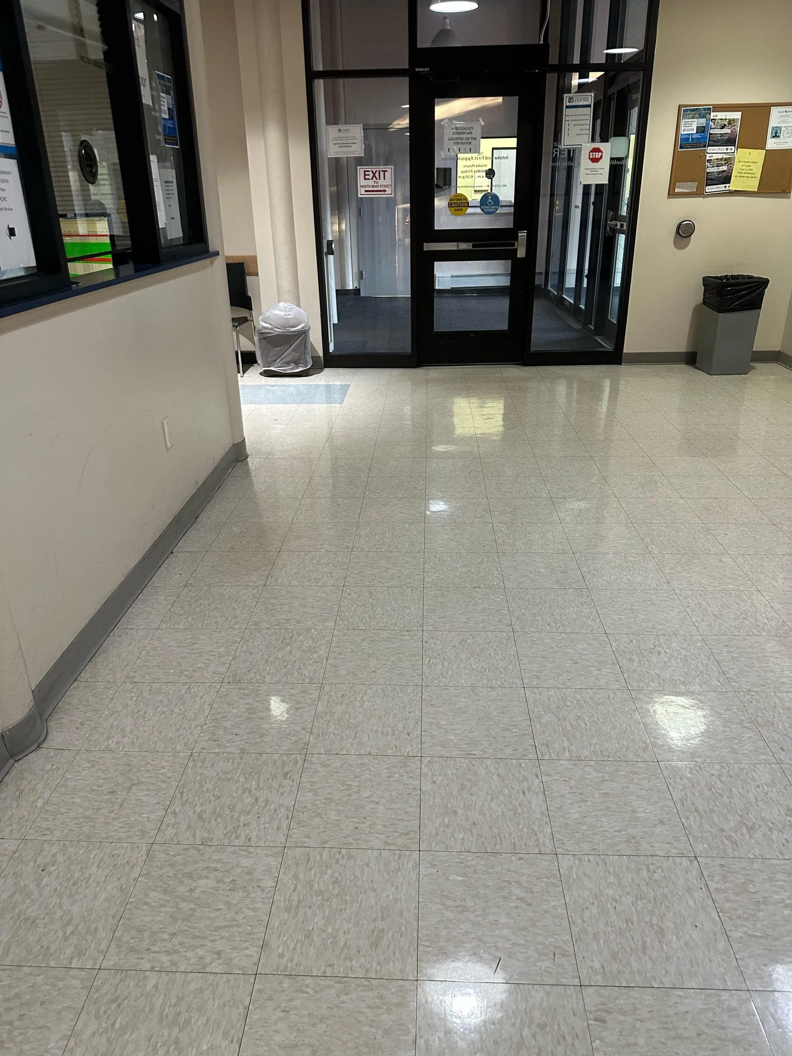 Polished tile lobby floor beside entrance doors after cleaning