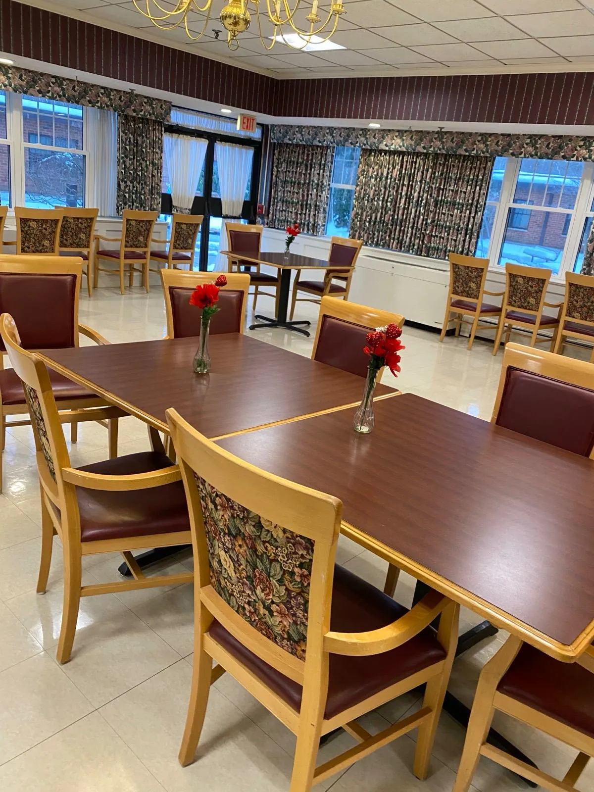 Dining room with wooden tables and a polished floor