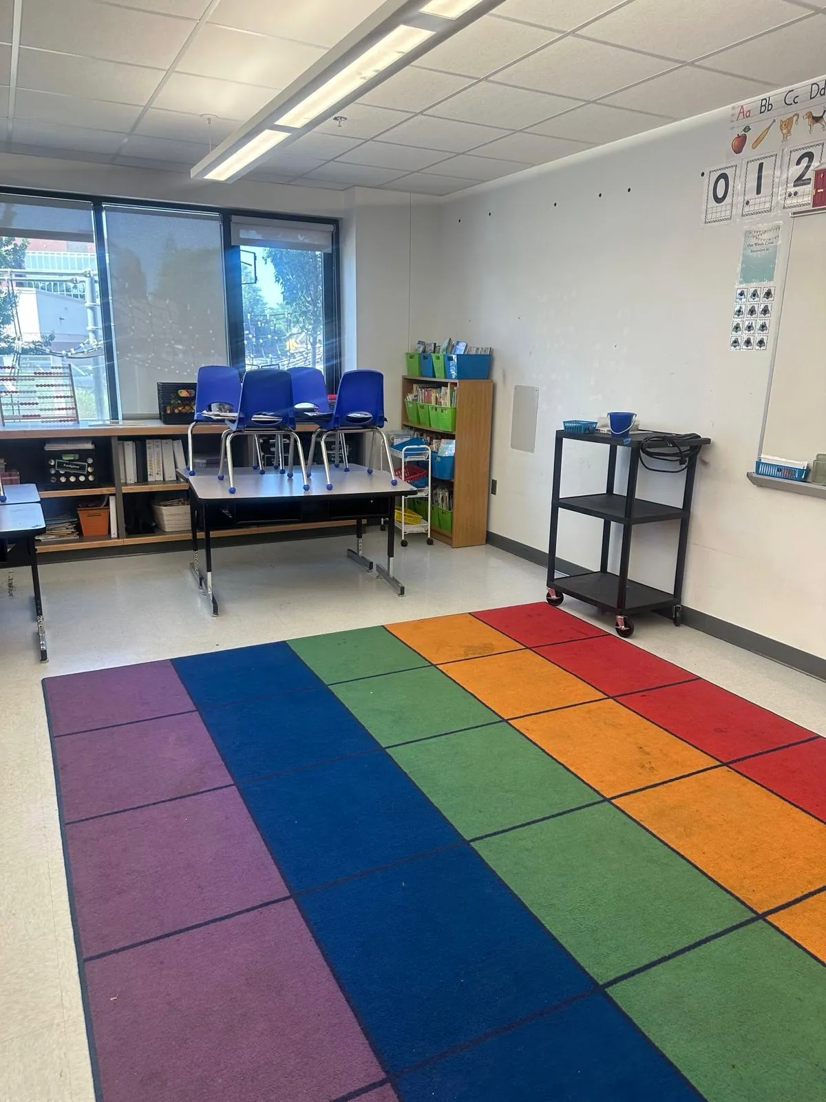 Classroom with a rainbow carpet and clean tile floor