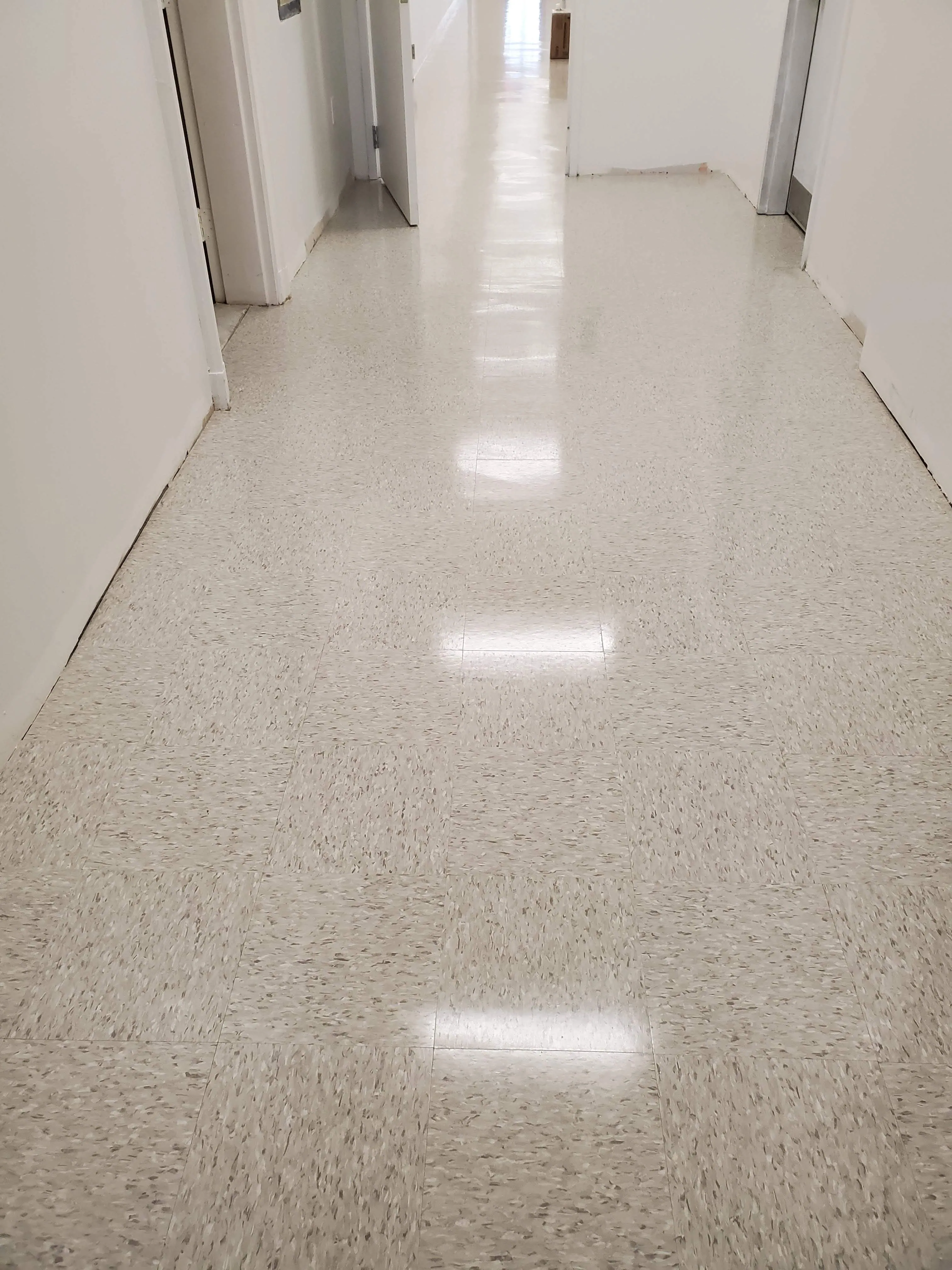 Long corridor with a glossy, freshly finished floor